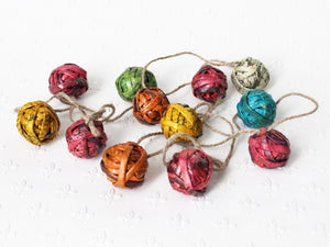 Newspaper ornaments, small - garland of 12 baubles; assorted colours
